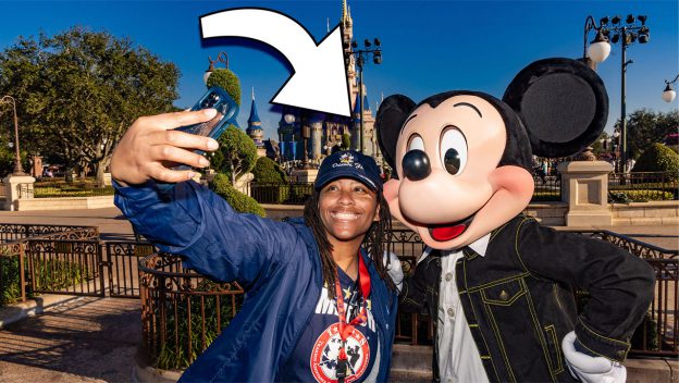 mickey taking a selfie with a lady