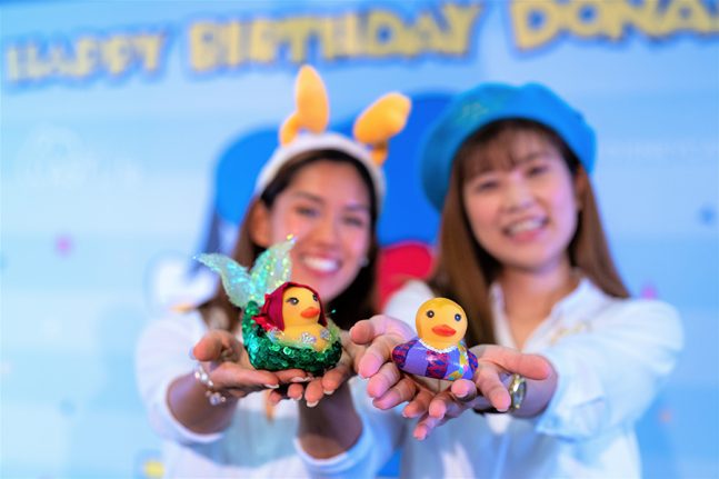 Hong Kong Disneyland cast members pose with their ducks