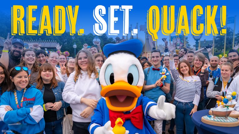 Cast members pose with Donald Duck
