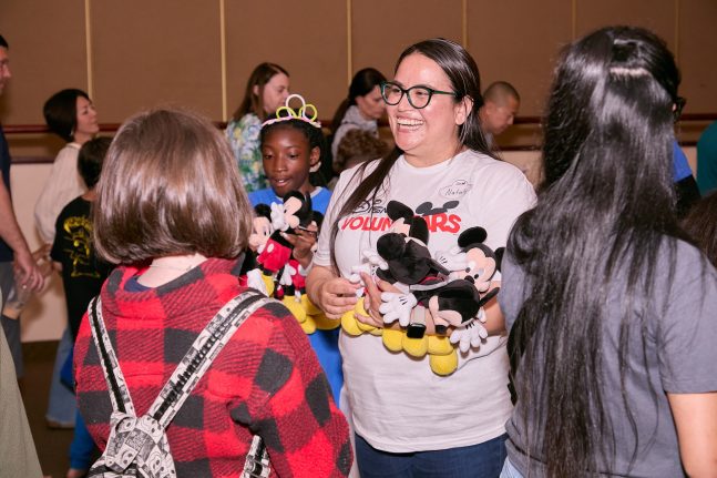 Disney Voluntear and military children with Mickey Mouse plush