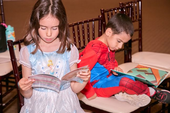 Military children engaging with Disney books 