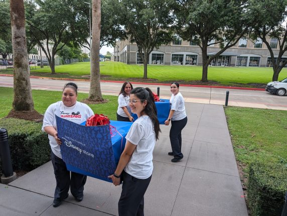 Disney VoluntEARS help bring in special care packages for the guests of the Houston Fisher House 