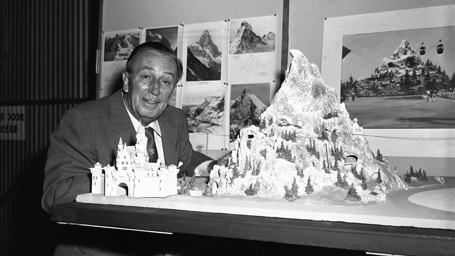 Walt Disney with a model of the Matterhorn Bobsleds Disneyland attraction