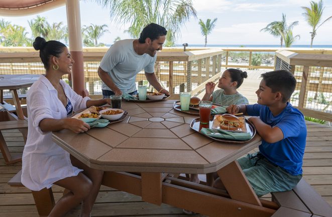 A family enjoys a meal at True-True Too BBQ at Disney Lookout Cay at Lighthouse Point