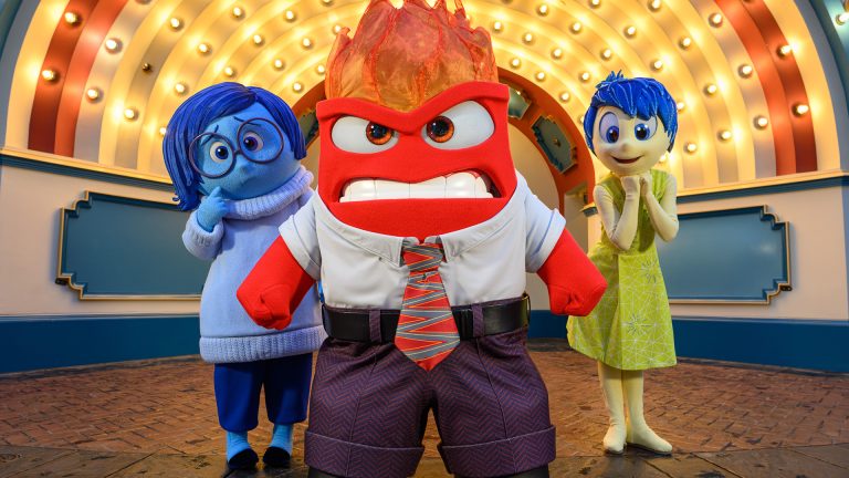 Anger poses in front of Joy and Sadness at Pixar Fest at Disneyland Resort