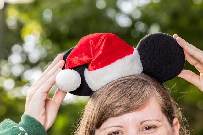 Model wearing classic Santa Mickey ears