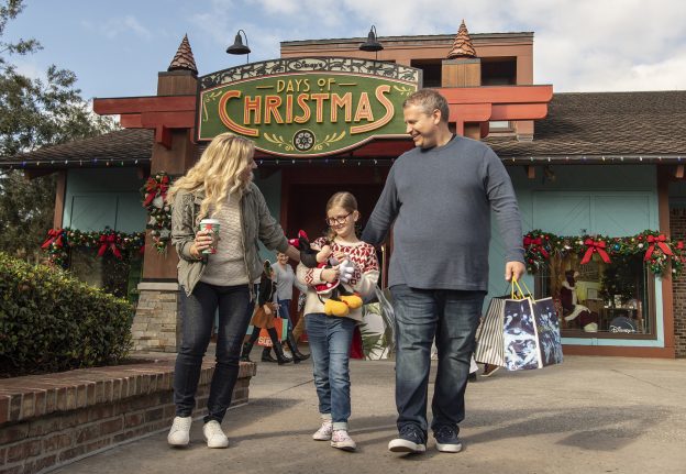 A family smiling outside Disney Days of Christmas at Disney Springs