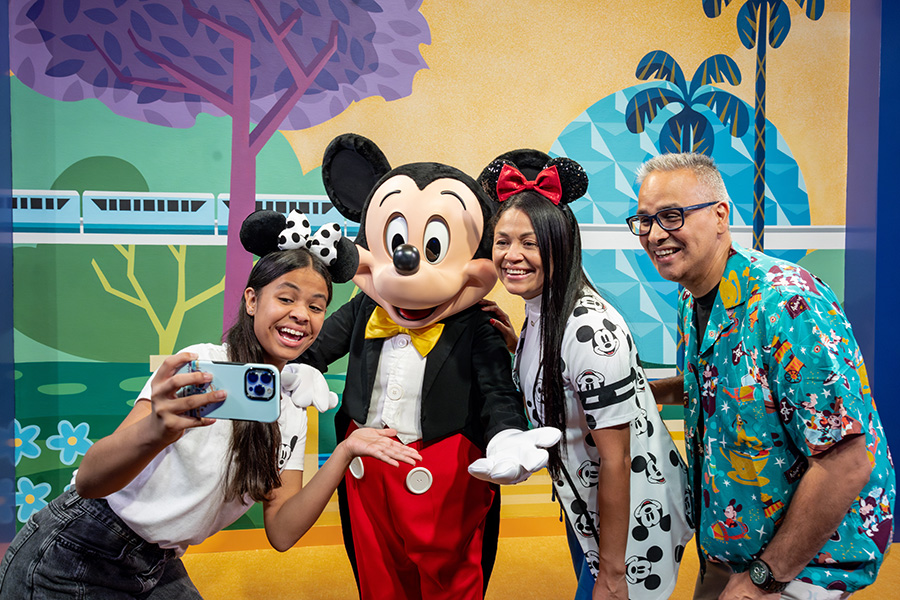 Mickey poses with guests at the new Mickey & Friends character greeting location