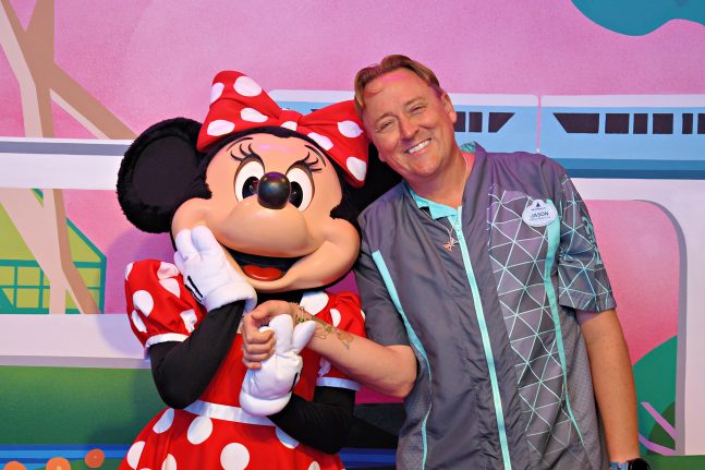 A cast member smiles with Minnie Mouse during a cast preview of Mickey & Friends at EPCOT