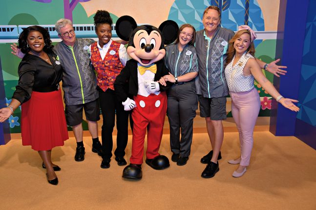 Cast members pose with Mickey Mouse and the Walt Disney World Ambassadors during a cast preview of Mickey & Friends at EPCOT
