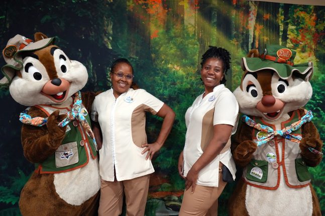 Cast members smile with Chip 'n' Dale at Disney's Wilderness Lodge