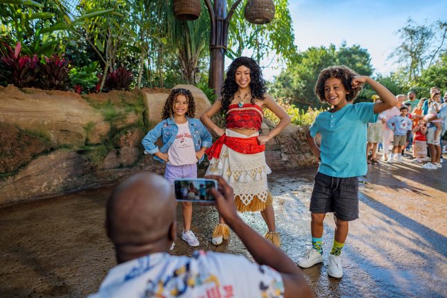 A family poses for a picture with Moana