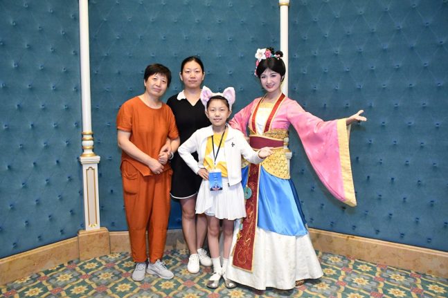 Xuanxuan and her family pose with Mulan