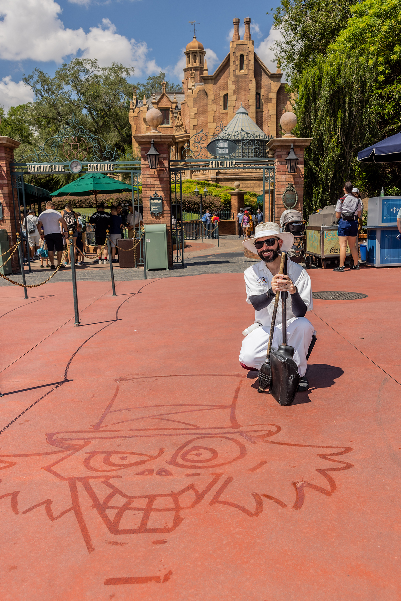 Joel poses in front of the Haunted Mansion with his completed Hatbox Ghost water art