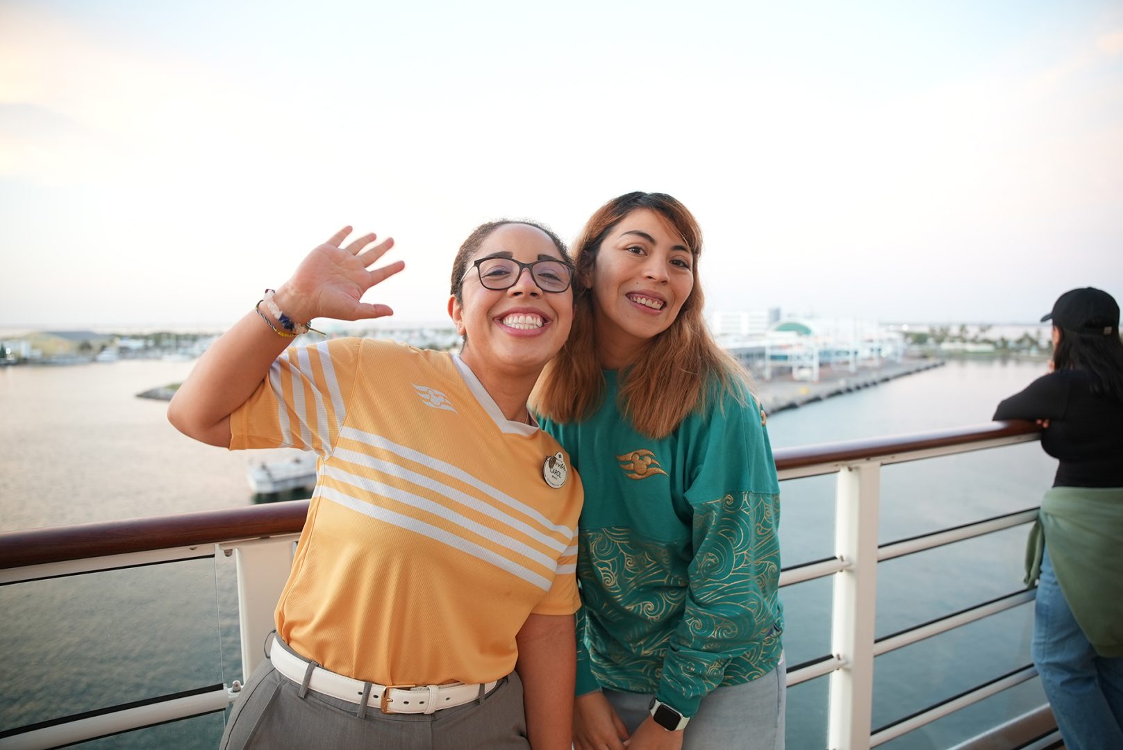 Two crew members pose onboard the Disney Treasure