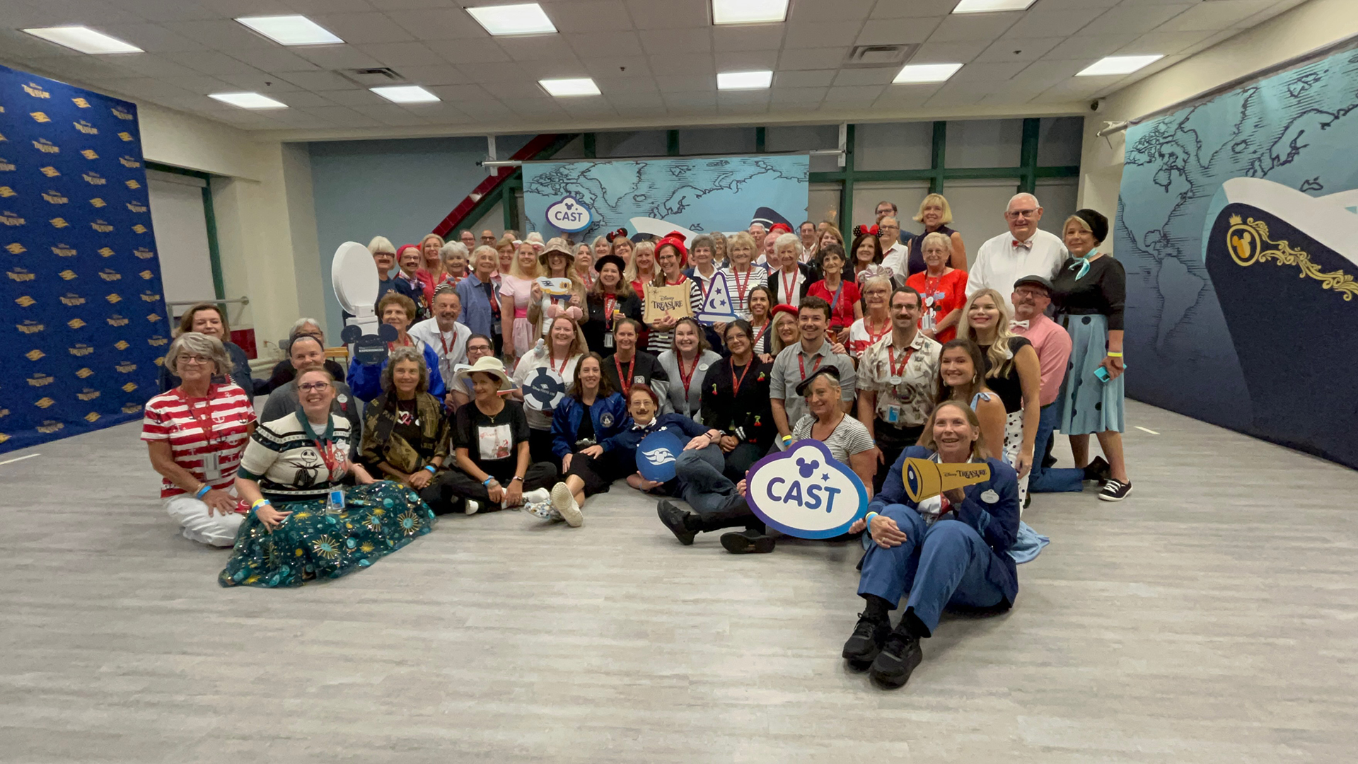 Crew members pose at the Disney Treasure welcome party