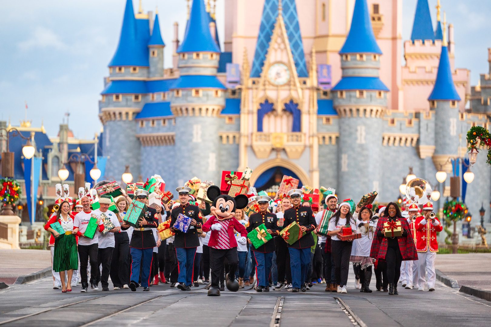 Mickey Mouse with cast members and local Marines in front of Cinderella Castle at Magic Kingdom