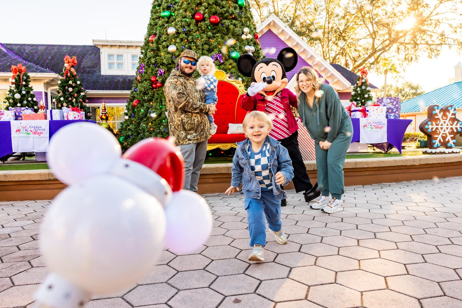 Mickey Mouse with a family at Give Kids the World Village