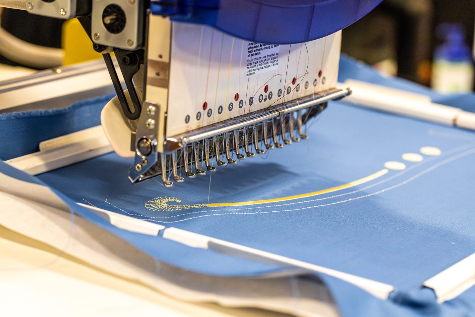 A cast member sews the new Voices of Liberty costumes