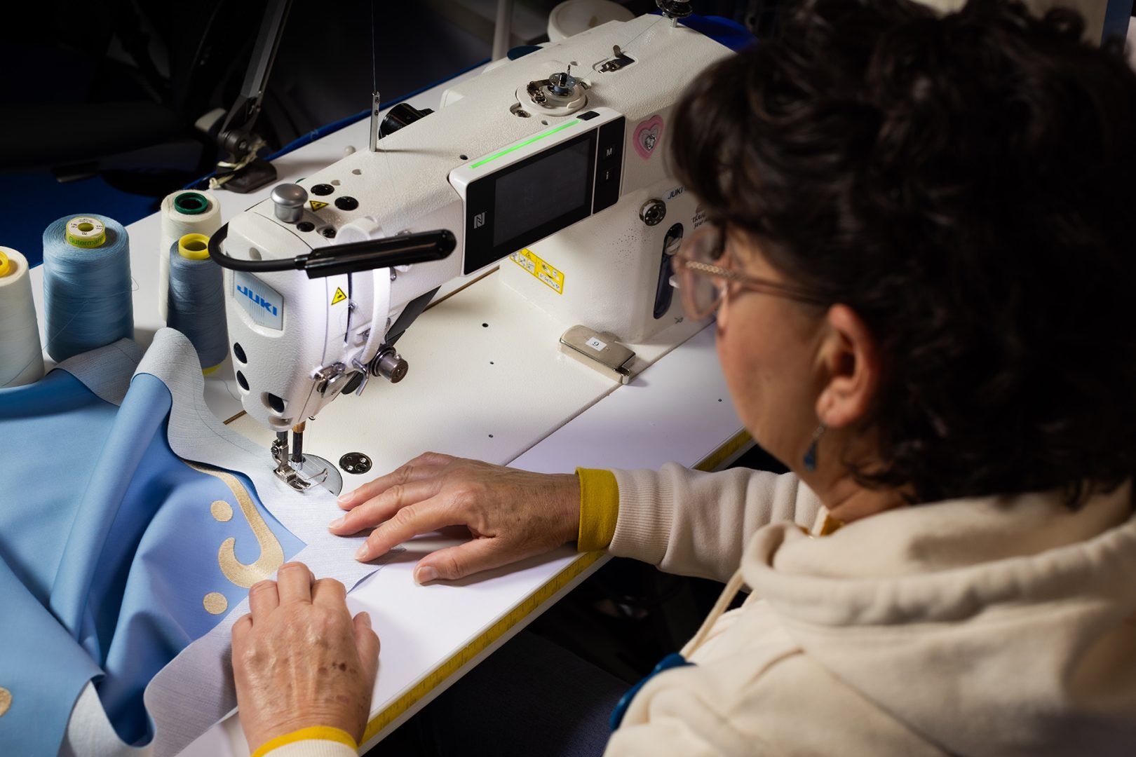 A cast member sews the new Voices of Liberty costumes