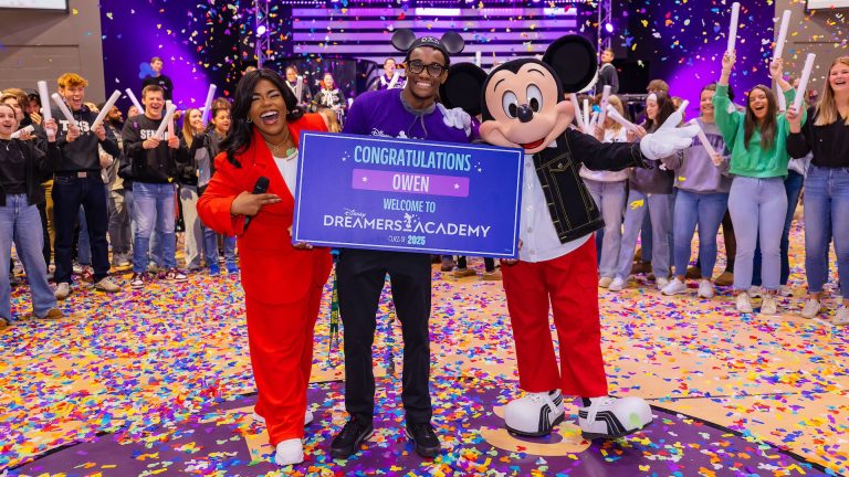 Mickey Mouse and Walt Disney World Ambassador Shannon-Smith Conrad pose with student