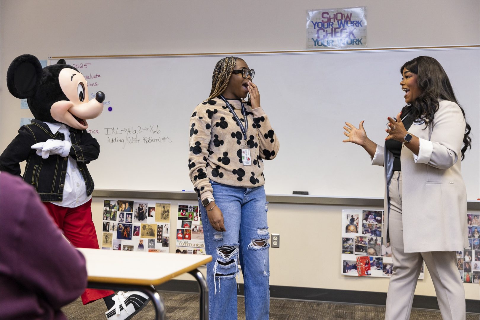 Mickey Mouse and Walt Disney World Ambassador Shannon-Smith Conrad pose with student