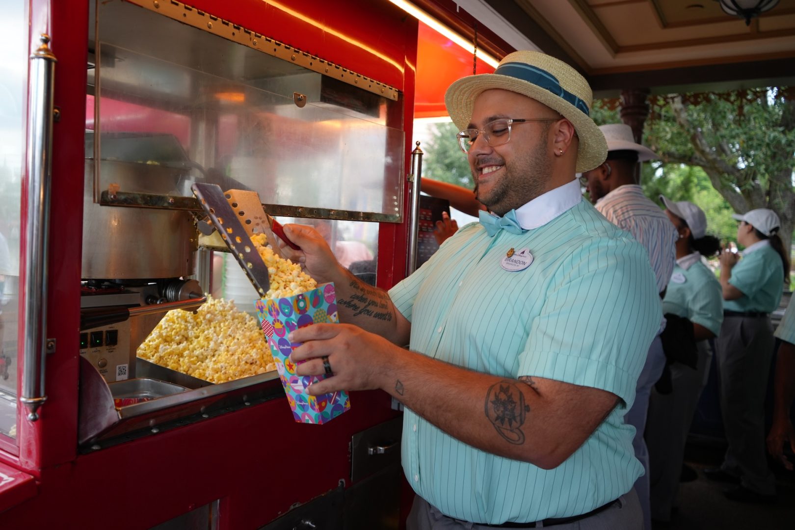 Brandon, Food & Beverage Cast Member scooping popcorn