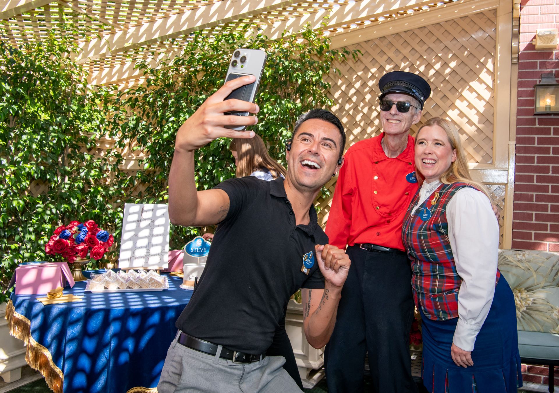 Three people smiling for a selfie at a celebration event.