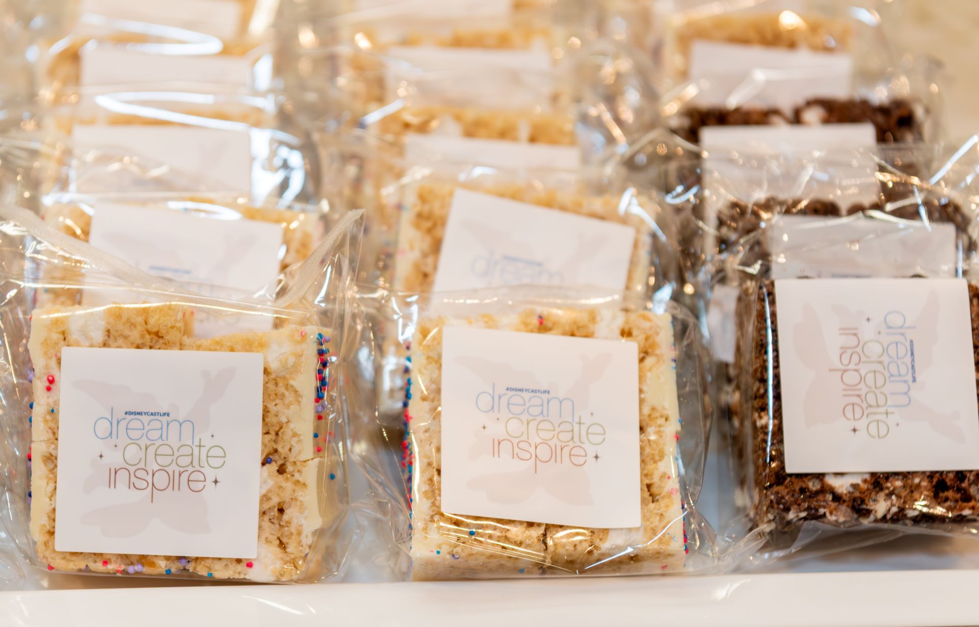 Packaged dessert treats with labels reading "dream, create, inspire."
