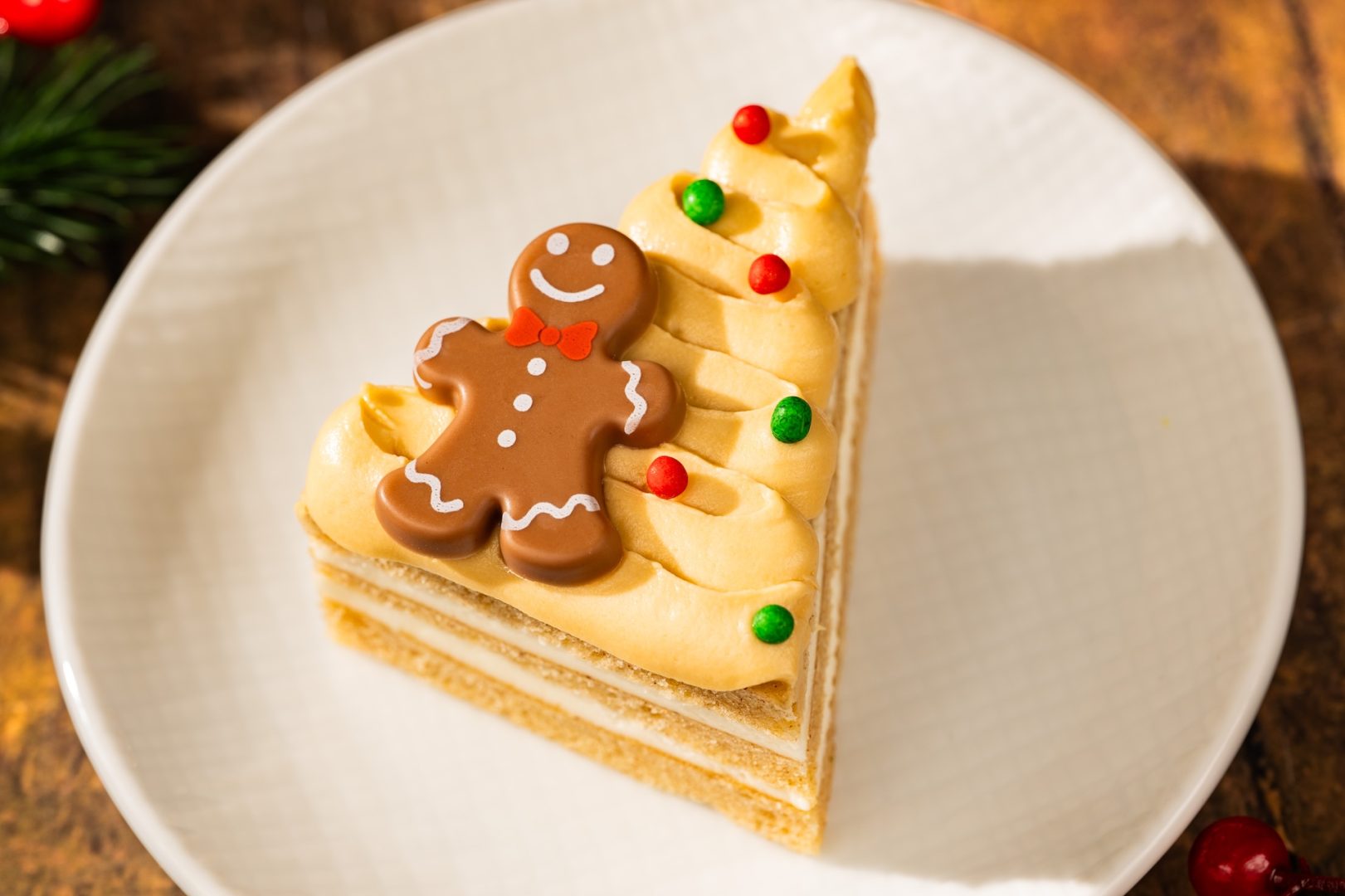 Gingerbread Cake: Tree-shaped gingerbread chiffon cake with cream cheese frosting, whipped dulce de leche panna cotta, crispy pearls, and a chocolate piece 
