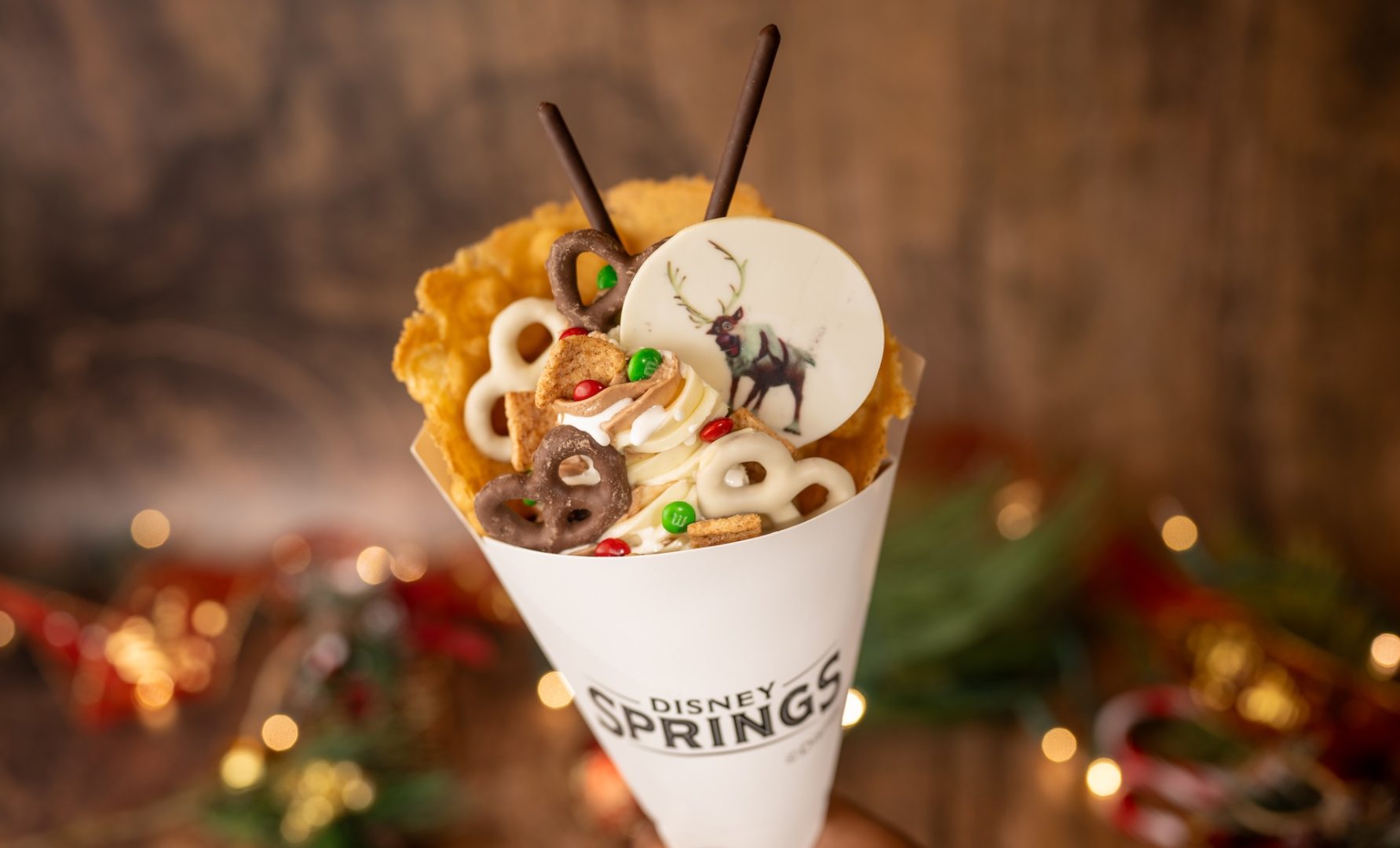 Sven Reindeer Food Waffle Sundae: Vanilla and chocolate soft-serve swirl, white and dark chocolate-coated pretzels, M&M’S Mini’s Milk Chocolate Candies Holiday Blend, cinnamon cereal, marshmallow sauce, and a white chocolate coin