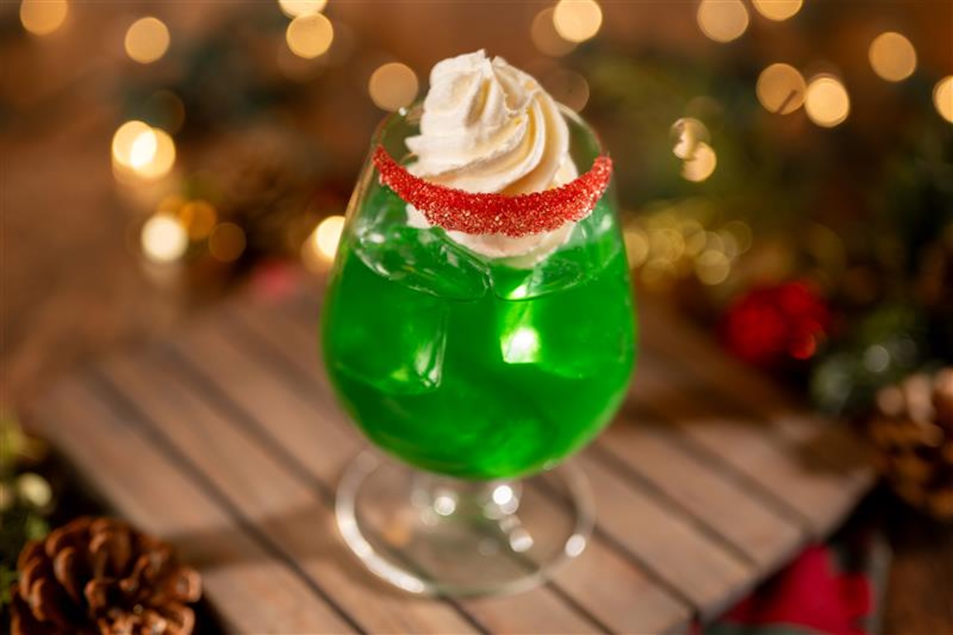 Tannenbaum: Malibu Coconut Rum, Midori Melon Liqueur, DOLE Pineapple Juice, and cream of coconut garnished with a red sugared rim, whipped cream 