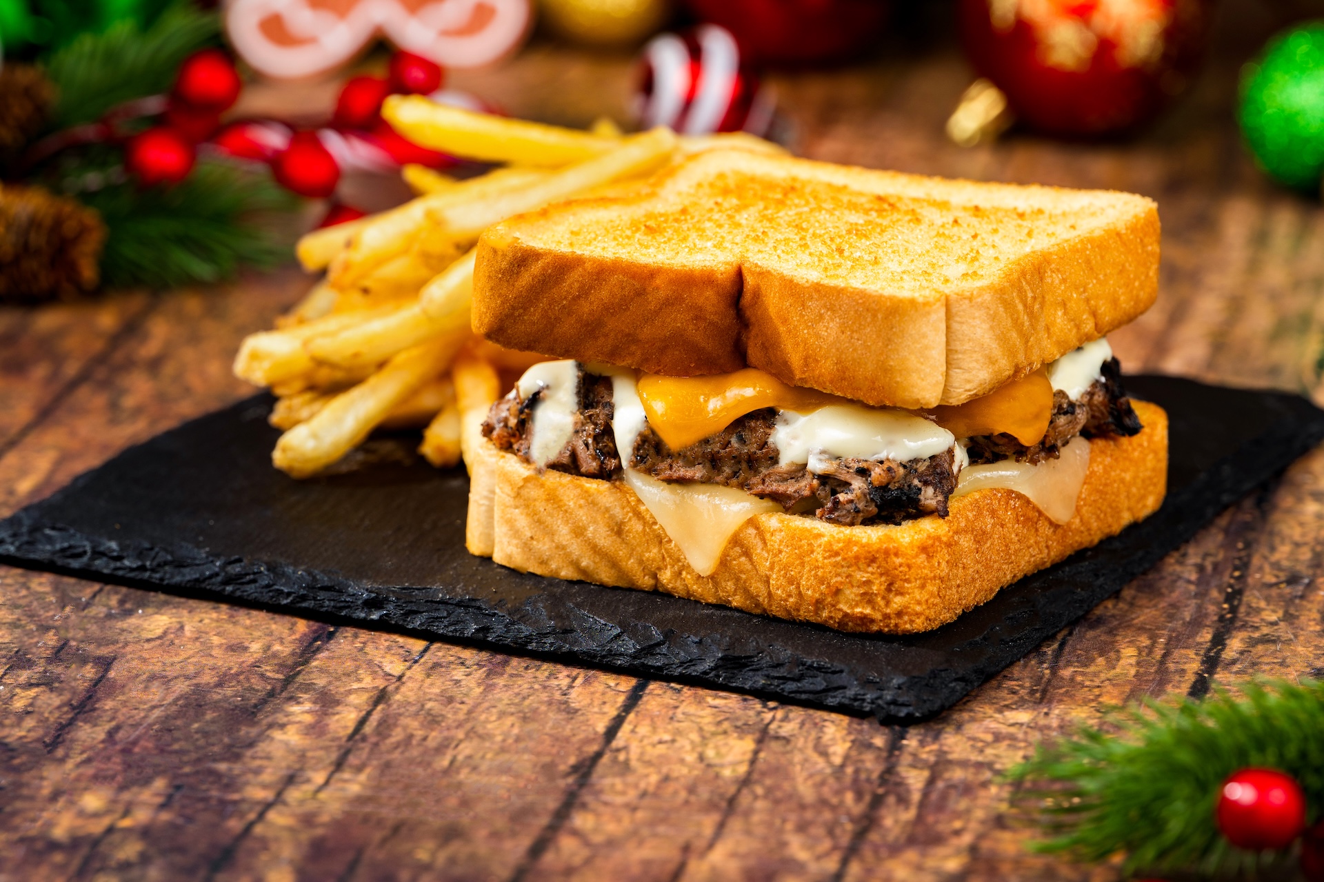 Holiday Pot Roast Melt: Slow-cooked beef on thick toast with cheddar, Swiss cheese, beef gravy, and horseradish cream sauce