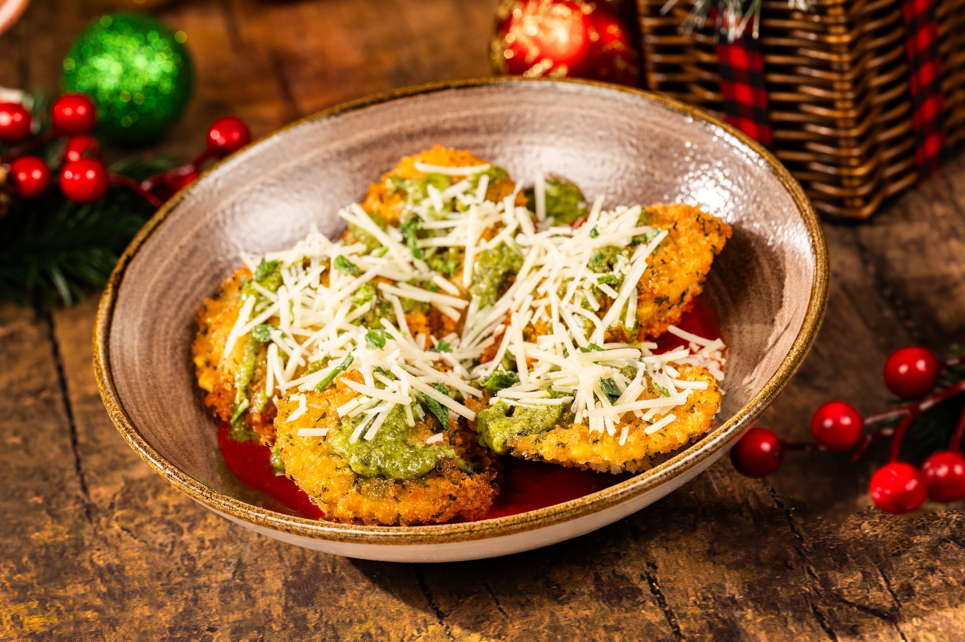 Holiday Ravioli: Fried breaded ravioli with marinara sauce, basil pesto, parmesan, and parsley