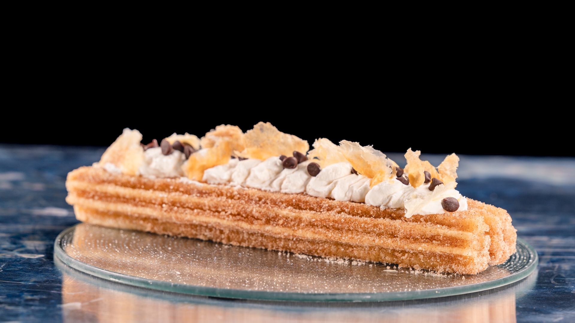 Cannoli Churro: Classic churro topped with cannoli cream, chocolate chips, and puff pastry
