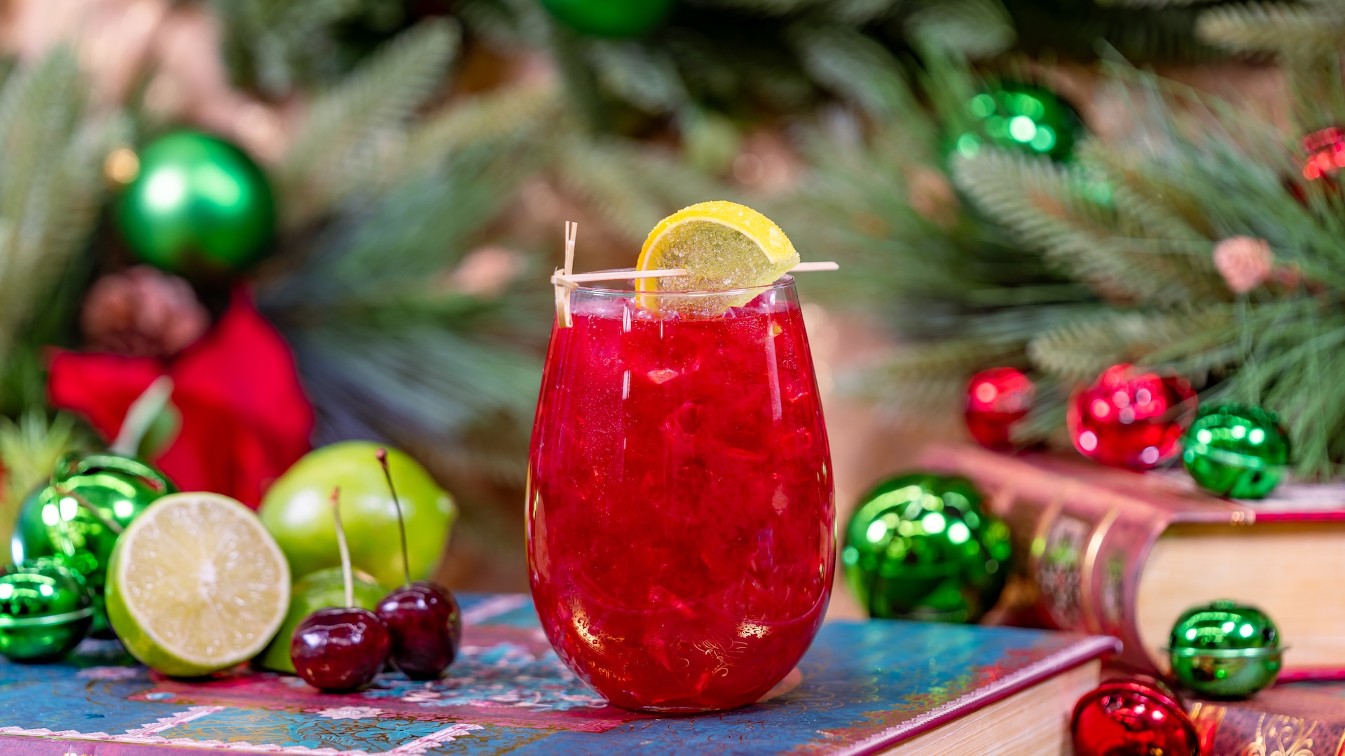 Cranberry Christmas Mule: Gin, elderflower and ginger liqueurs, cherry purée, and cranberry and lime juices topped with a citrus hard seltzer and garnished with a lime wedge gummy candy
