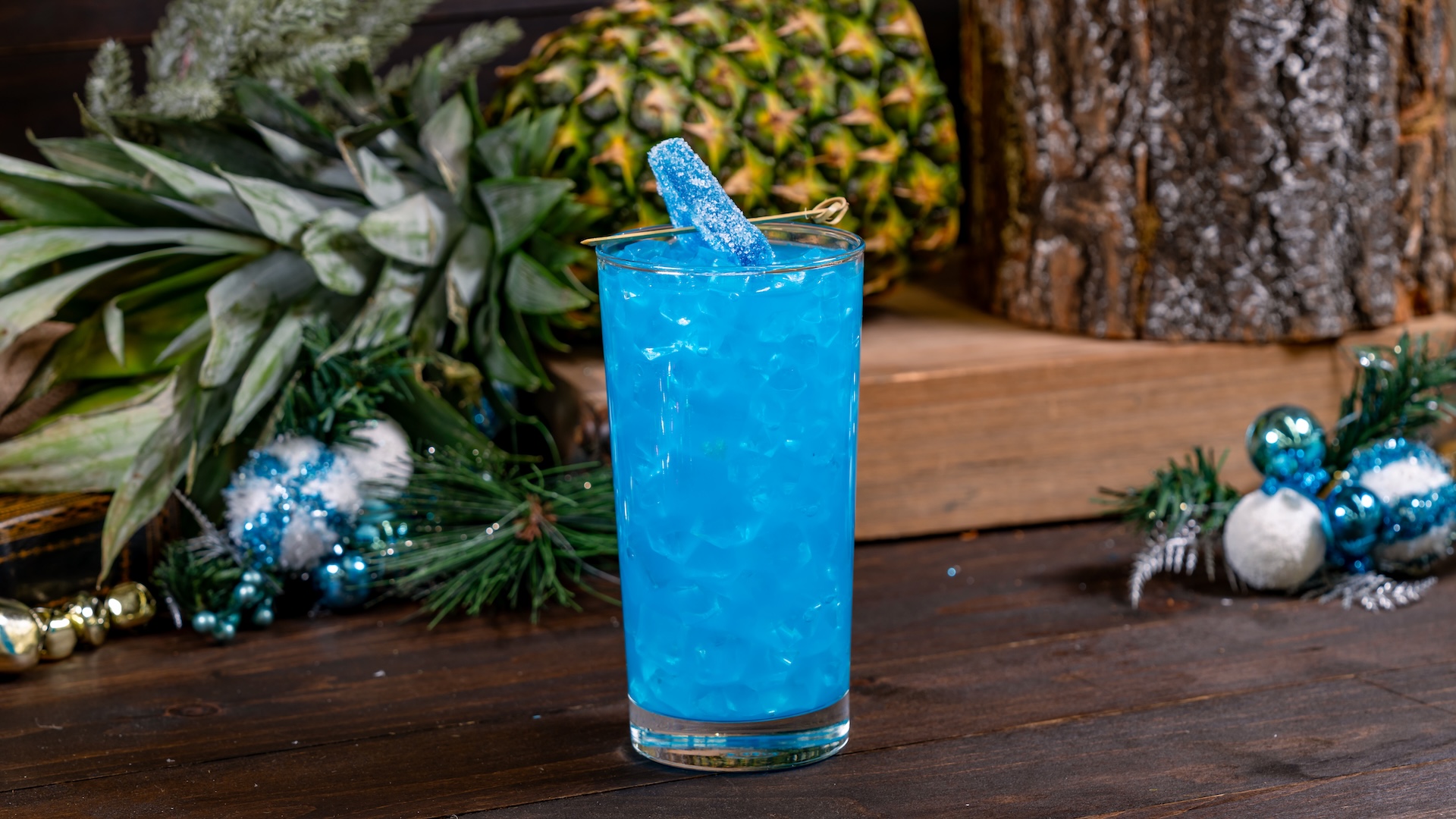 Tropical Holiday Punch: Pineapple, orange and lemon juices, blue raspberry syrup, and coconut purée garnished with a blue raspberry gummy candy (Non-alcoholic) (New)