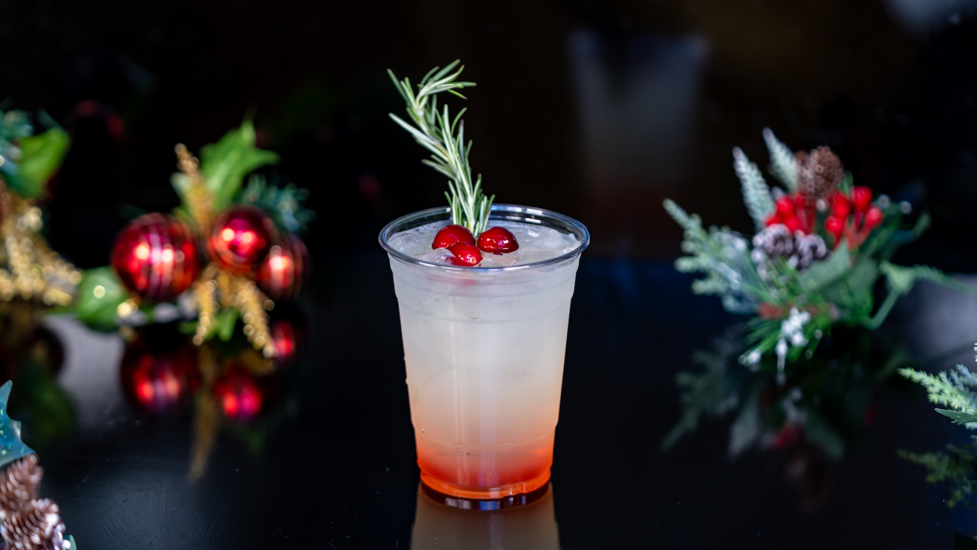 Very Merry Cran-Peary: Minute Maid Zero Sugar Lemonade with cranberry and pear syrups garnished with cranberries and a fresh rosemary sprig (Non-alcoholic) 