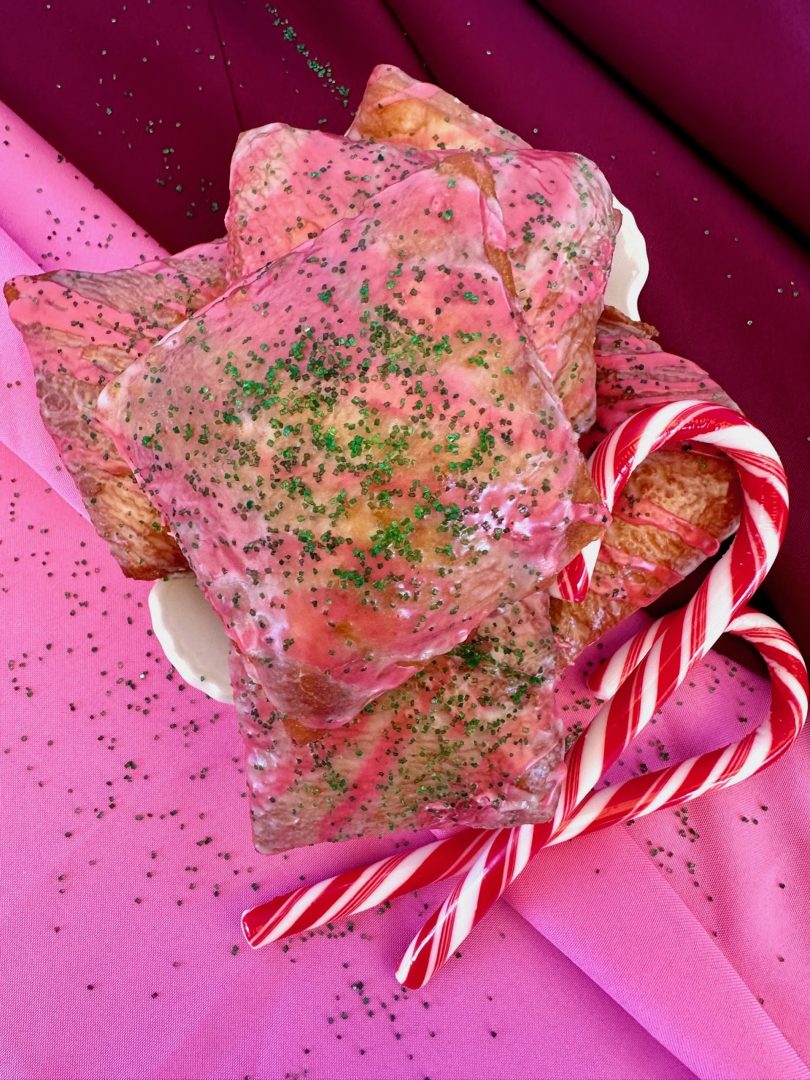 Candy Cane Twist Glazed Beignet: Beignet coated in a frosty peppermint glaze with crushed green candy 