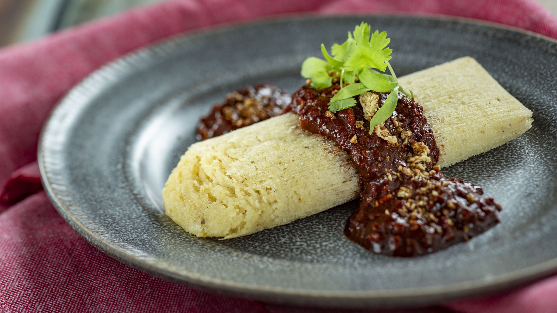 Plant-based Chorizo Tamale with plant-based cotija and spicy red chile sauce (Plant-based)