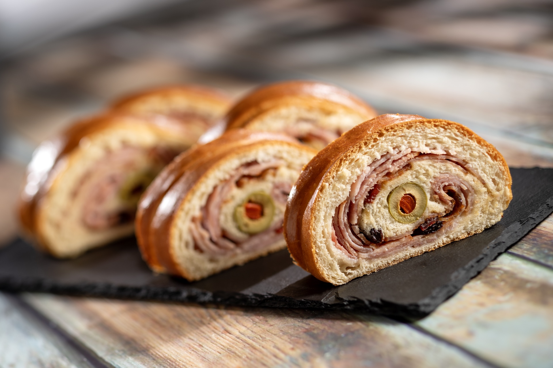 Pan de Jamón: Traditional Latin Christmas bread, rolled ham, raisins, and green olives (New)