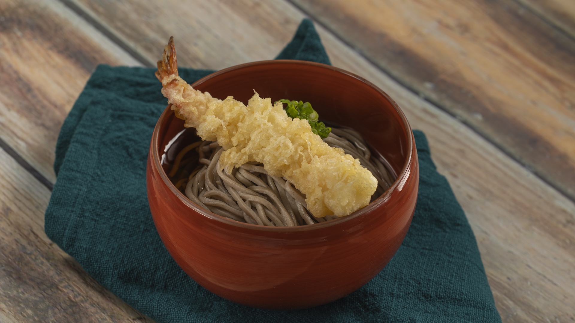 Toshikoshi Soba: Buckwheat soba noodles in hot dashi fish-based soup topped with shrimp tempura and chopped green onion