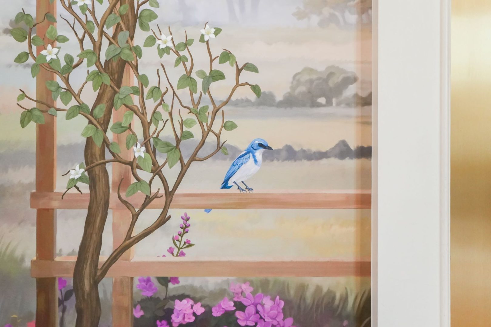 Colorful mural featuring a bluebird and blooming flowers.