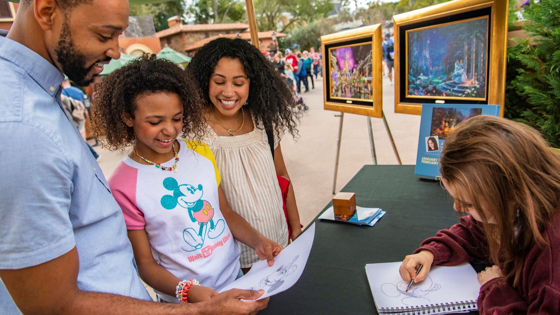 Family observing artwork while an artist sketches at EPCOT Festival.