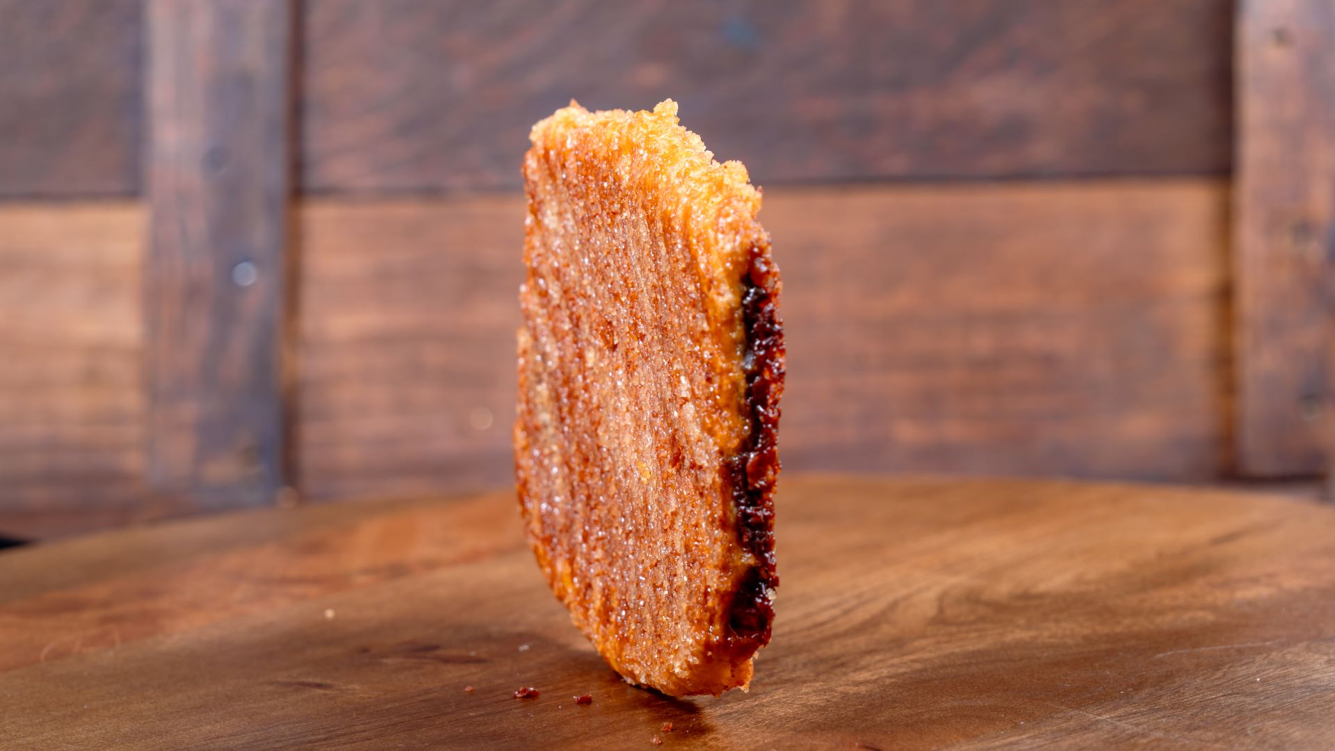 Chocolate croissant cookie on a wooden surface with a rustic background.