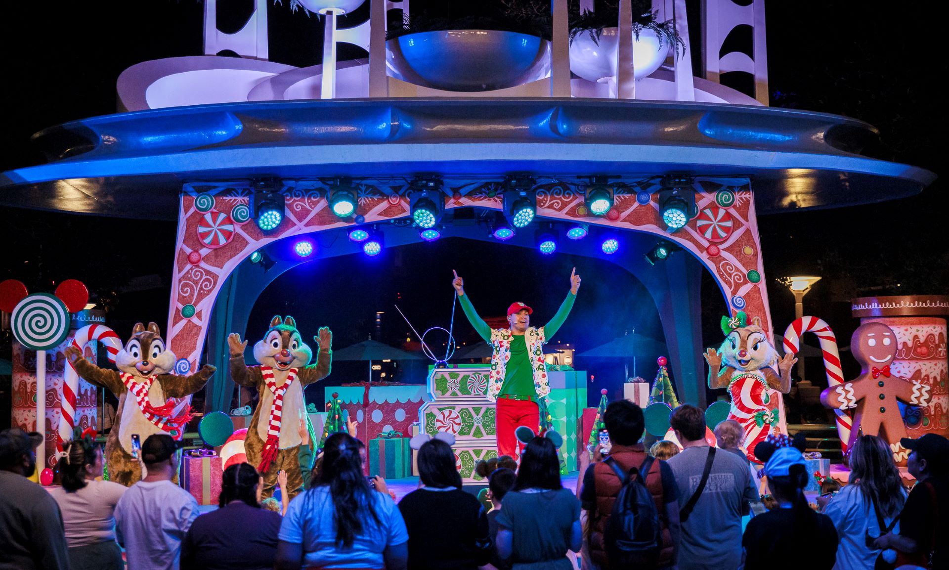 Holiday dance party featuring characters on stage with festive decorations.