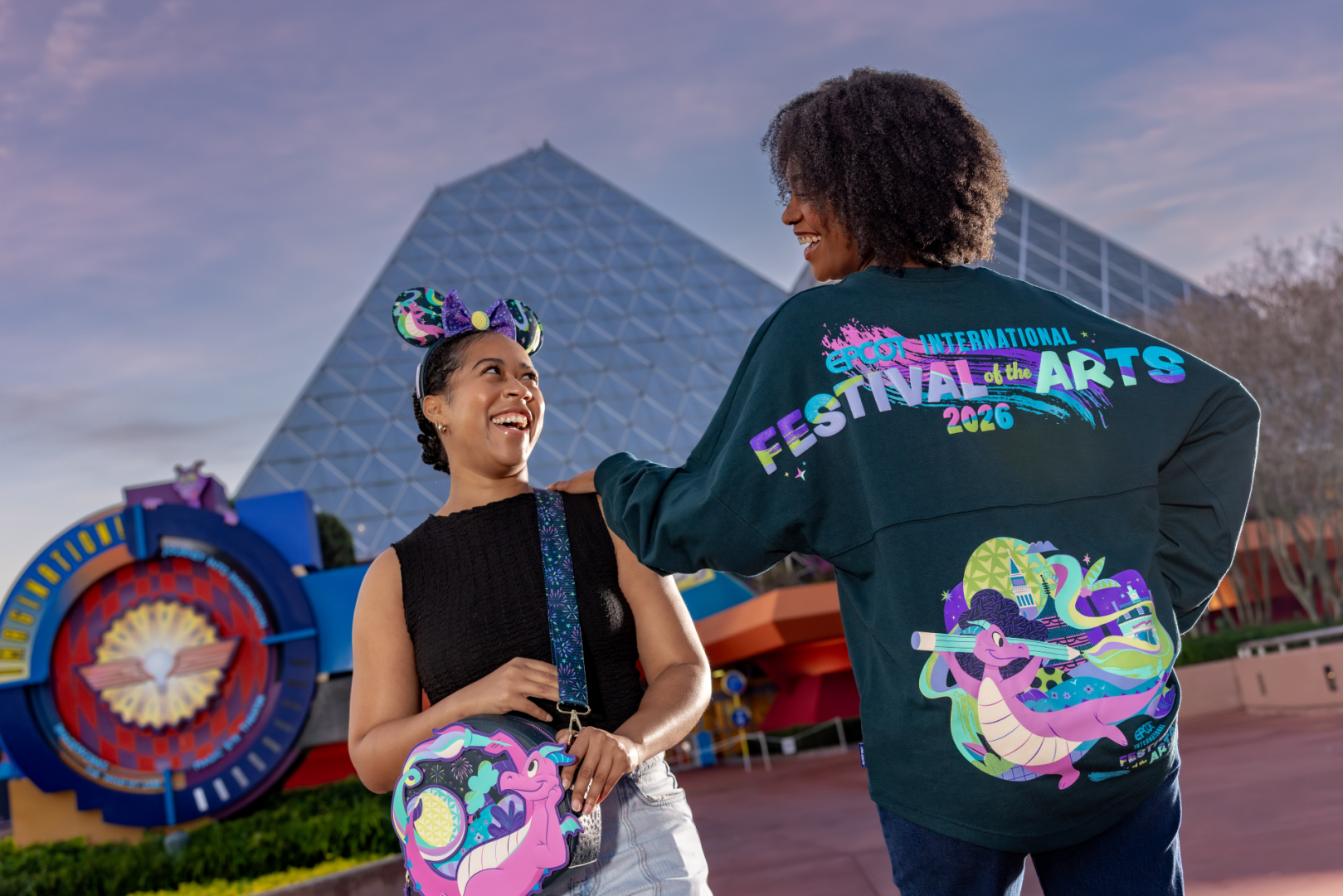 Two women smiling, wearing Festival of the Arts merchandise at EPCOT.