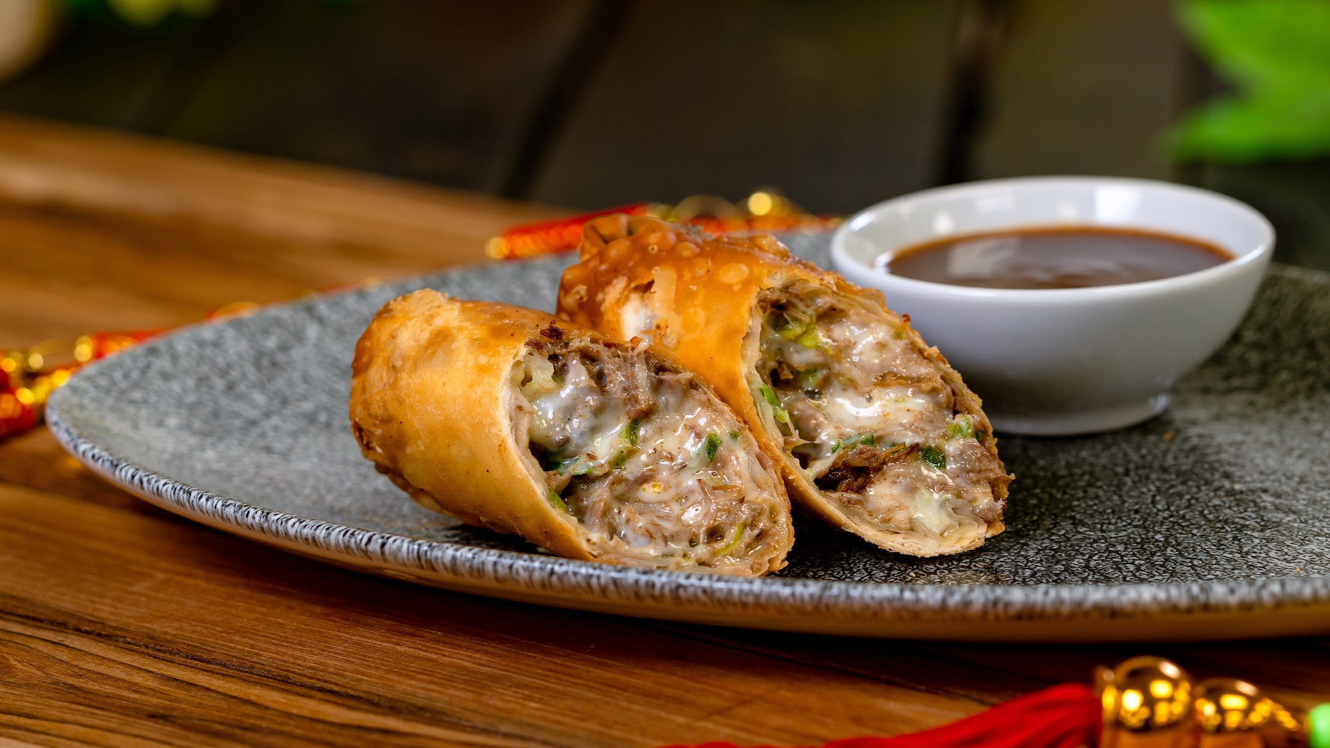 Quesabirria Eggroll with guajillo pepper consom&eacute;
