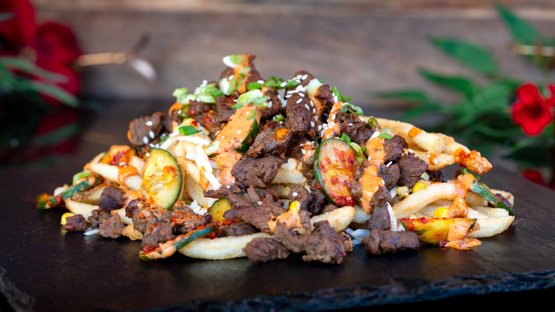 🍽️ Bulgogi Fries: Fries with marinated bulgogi beef, kimchi, cucumber, mozzarella cheese, and gochujang a&iuml;oli topped with sesame seeds and green onions (New)