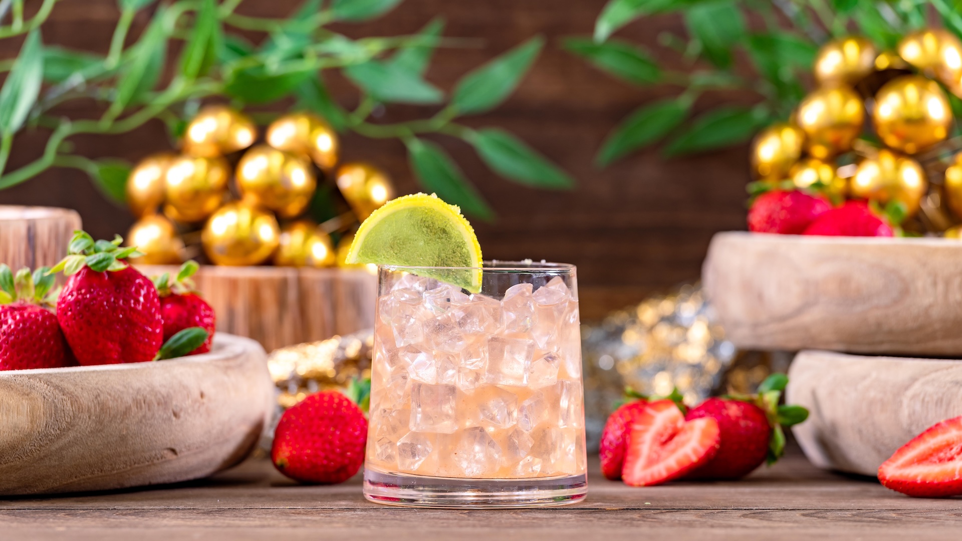 Strawberry Lychee Cocktail: Bourbon, strawberry pur&eacute;e, lychee syrup, and lime juice garnished with a lime gummy wedge